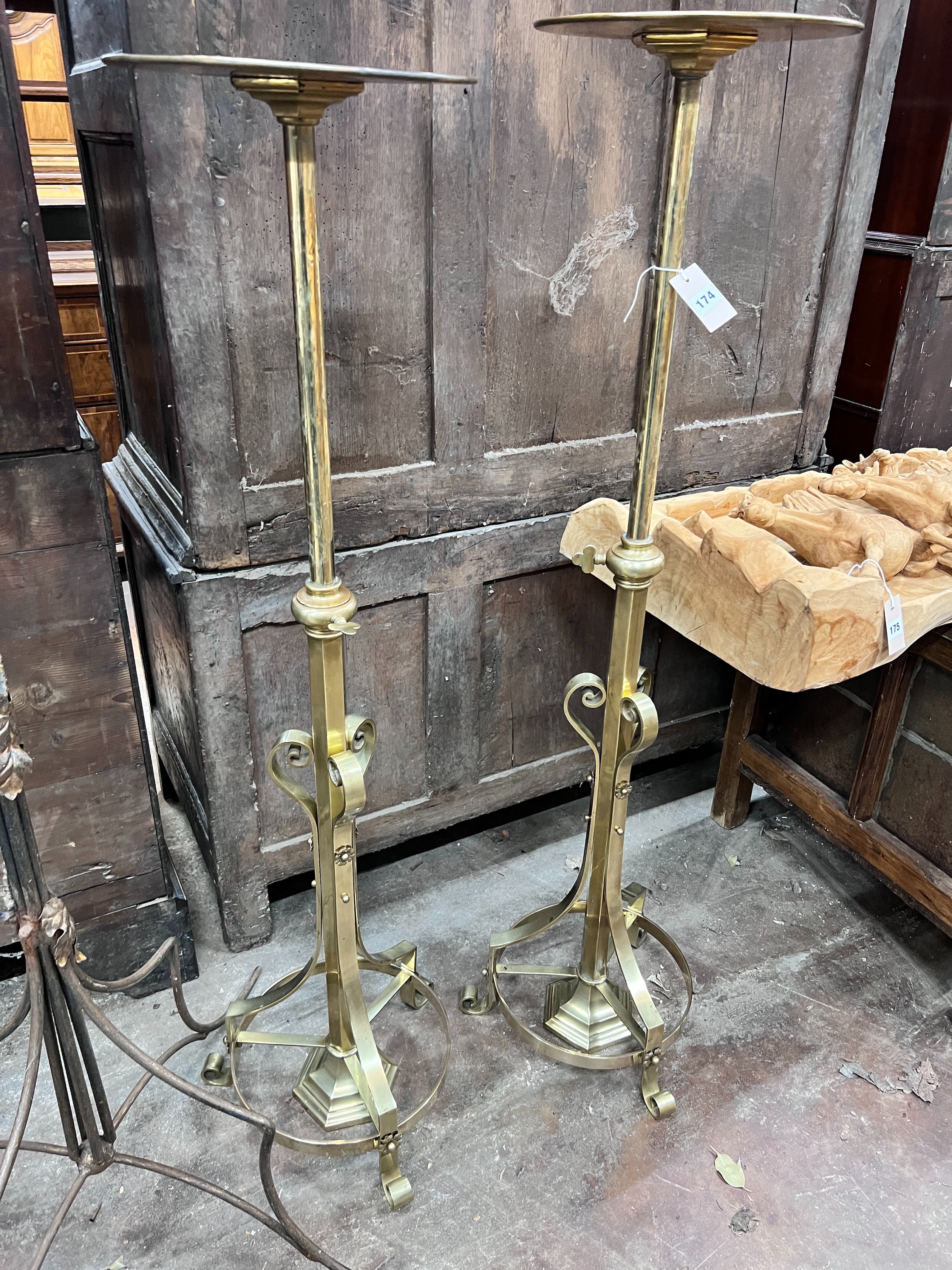 A pair of ecclesiastical brass telescopic candle stands, maximum height 135cm *Please note the sale commences at 9am.